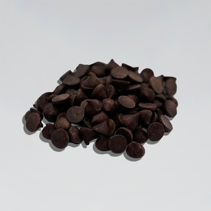 Organic Peruvian Chocolate dark Drops/Chips: A pile of organic Peruvian chocolate drops/chips, highlighting their small, round shape and rich, dark color, ideal for baking and confectionery uses.