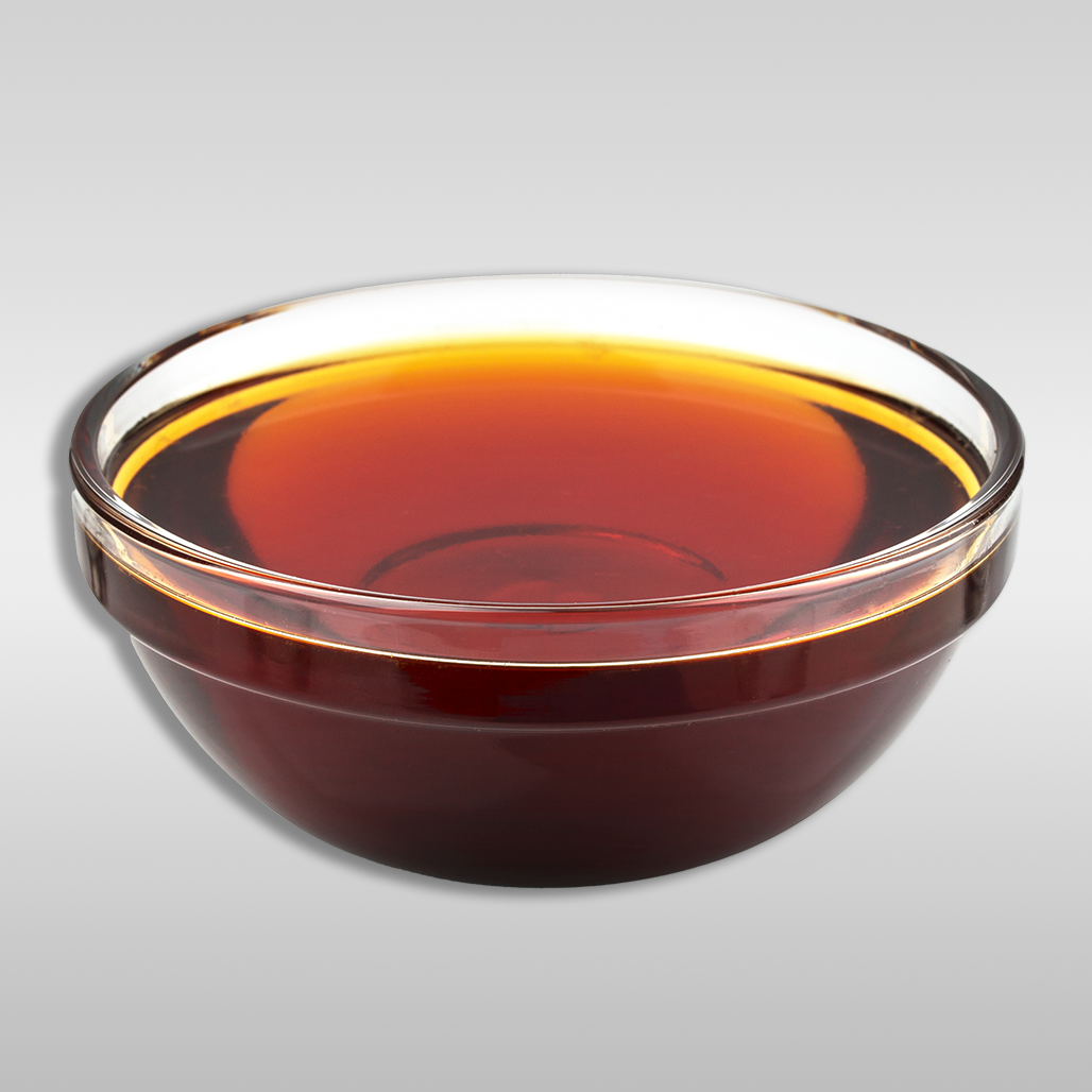 Rich, amber-colored Yacon Syrup, highlighting its smooth texture and appealing caramel hue.